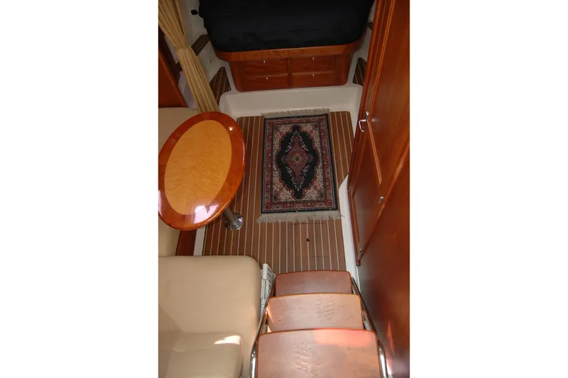 Au Lapin Agile Yacht Photos Pics Interior of 2014 Back Cove 34 boat with wooden finishes and decorative rug.