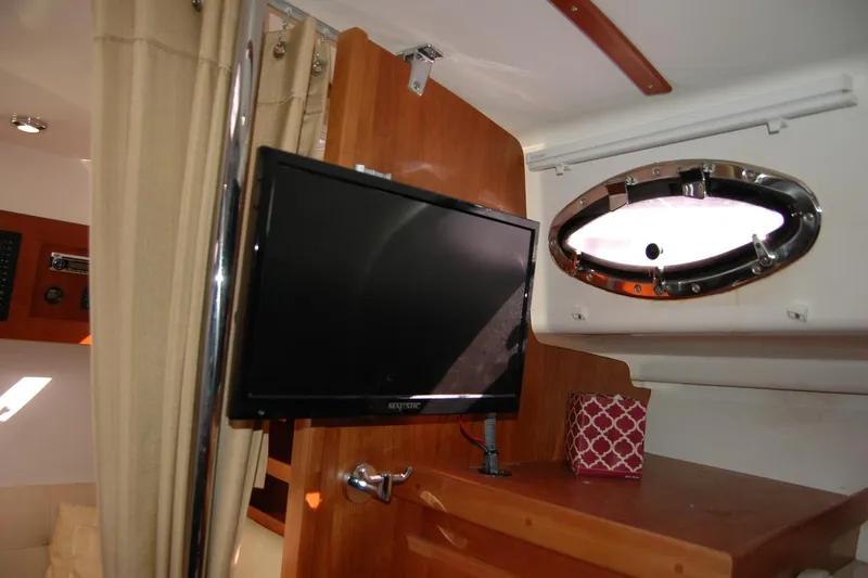 Au Lapin Agile Yacht Photos Pics Interior of 2014 Back Cove 34 boat with TV and porthole window.