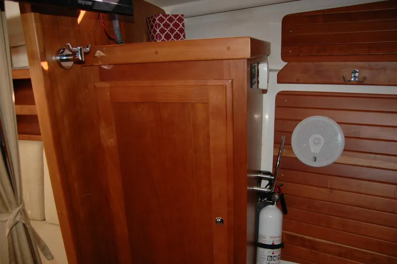 Au Lapin Agile Yacht Photos Pics Interior of 2014 Back Cove 34 boat with wooden cabinetry and safety equipment.