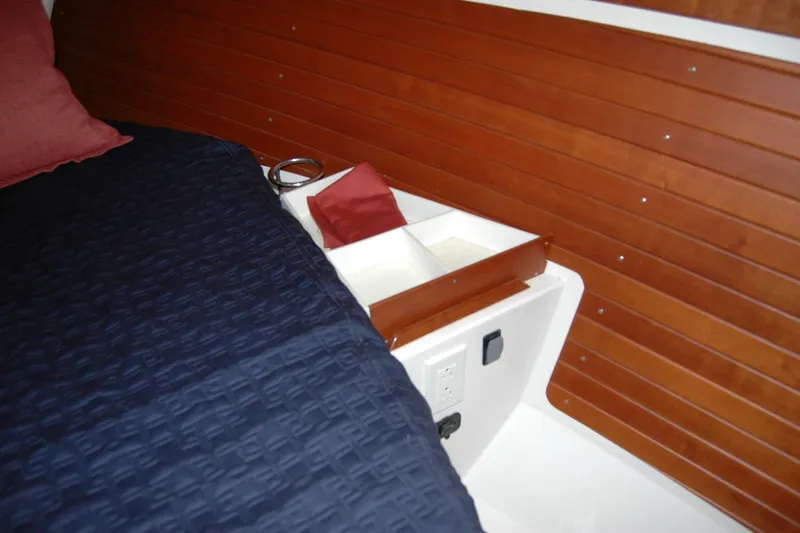 Au Lapin Agile Yacht Photos Pics Interior of 2014 Back Cove 34 boat with wooden paneling and bed.