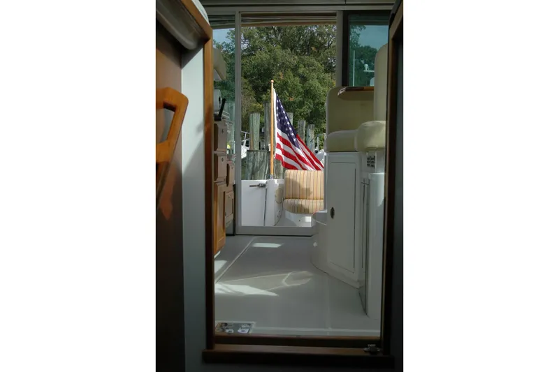 Au Lapin Agile Yacht Photos Pics Interior view of 2014 Back Cove 34 boat with American flag visible through doorway.