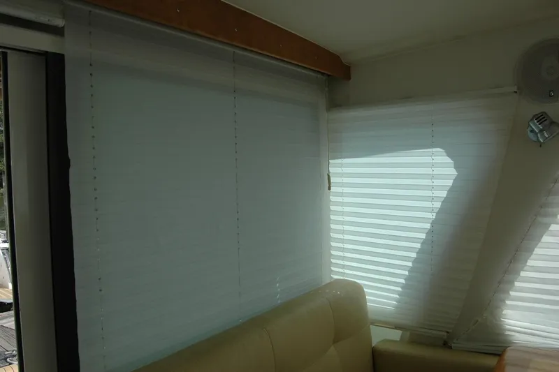 Au Lapin Agile Yacht Photos Pics Interior of 2014 Back Cove 34 yacht with window blinds and seating area.