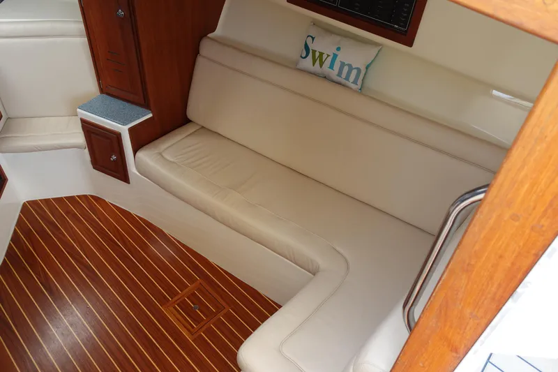  Yacht Photos Pics Interior of 2002 Carolina Classic 35 boat with beige seating and wooden flooring.