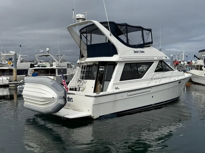  Yacht Photos Pics 2001 Bayliner 3988 Command Bridge Motoryacht docked in a marina, overcast sky.