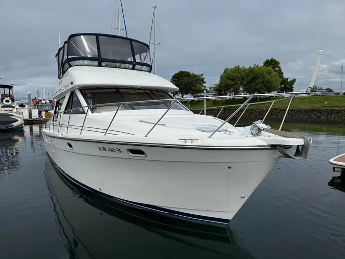  Yacht Photos Pics 2001 Bayliner 3988 Command Bridge Motoryacht docked in a marina, overcast sky.