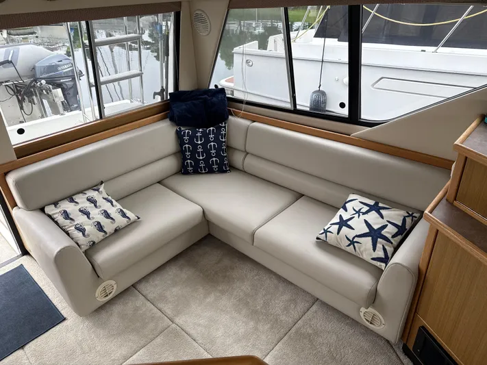  Yacht Photos Pics Luxurious interior of 2001 Bayliner 3988 Command Bridge Motoryacht with plush seating and nautical-themed pillows.