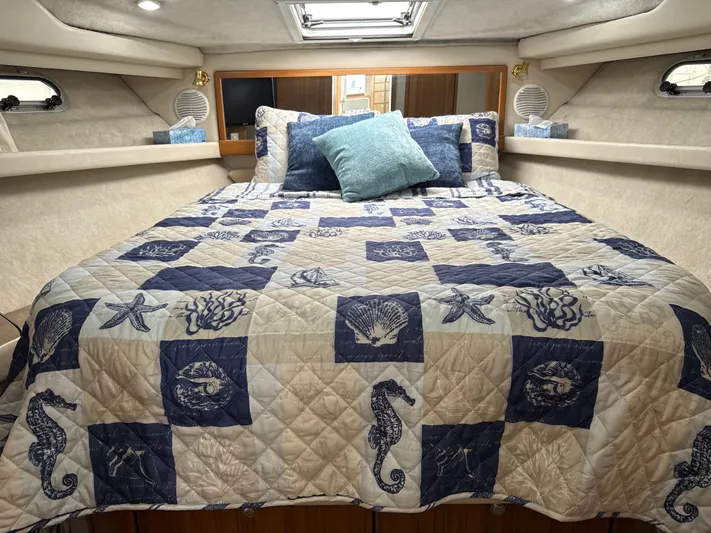  Yacht Photos Pics Cozy bedroom in 2001 Bayliner 3988 Command Bridge Motoryacht with nautical-themed bedding.