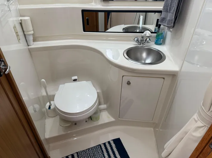  Yacht Photos Pics Bathroom in 2001 Bayliner 3988 Command Bridge Motoryacht with toilet, sink, and mirror.