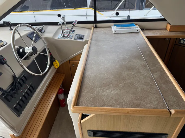  Yacht Photos Pics 2001 Bayliner 3988 Command Bridge Motoryacht helm with steering wheel and control panel.