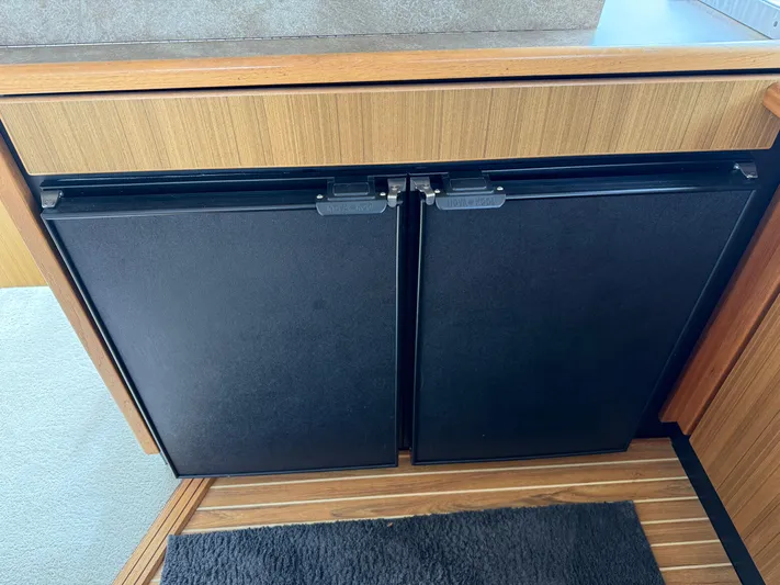  Yacht Photos Pics 2001 Bayliner 3988 Command Bridge Motoryacht interior with dual black fridge doors.