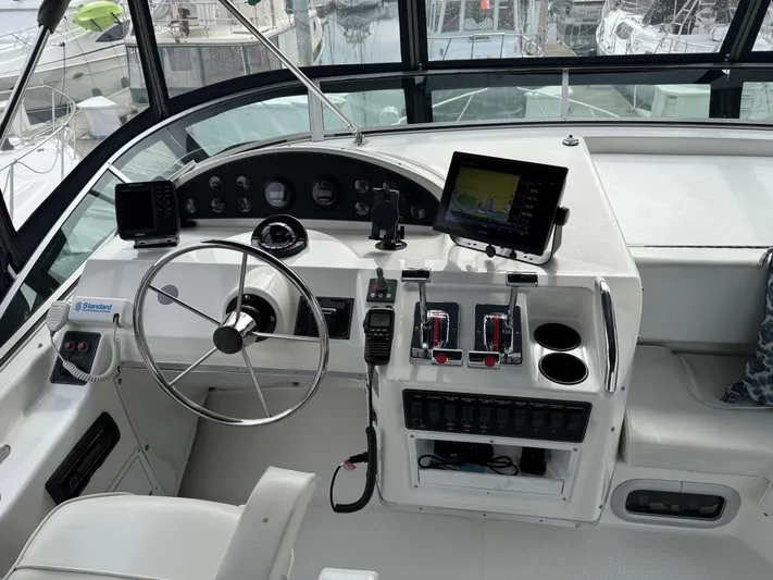  Yacht Photos Pics 2001 Bayliner 3988 Command Bridge Motoryacht helm with steering wheel, controls, and navigation equipment.