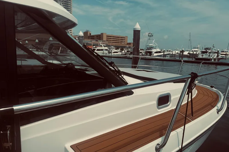 Last Tango Yacht Photos Pics 2020 Jeanneau NC 1095 boat docked at marina with wooden deck and clear sky.