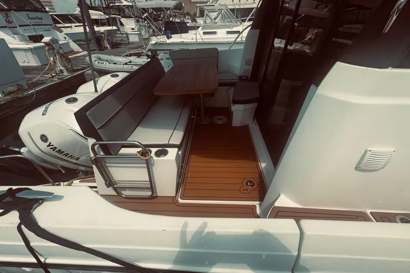 Last Tango Yacht Photos Pics Jeanneau NC 1095 2020 boat deck with seating and Yamaha engines at marina.