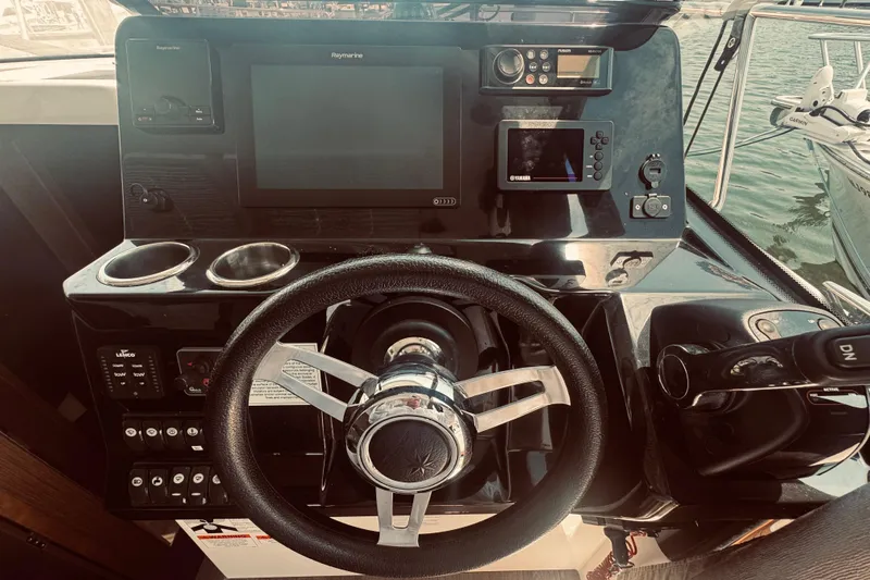 Last Tango Yacht Photos Pics Steering console of 2020 Jeanneau NC 1095 boat with navigation equipment and controls.
