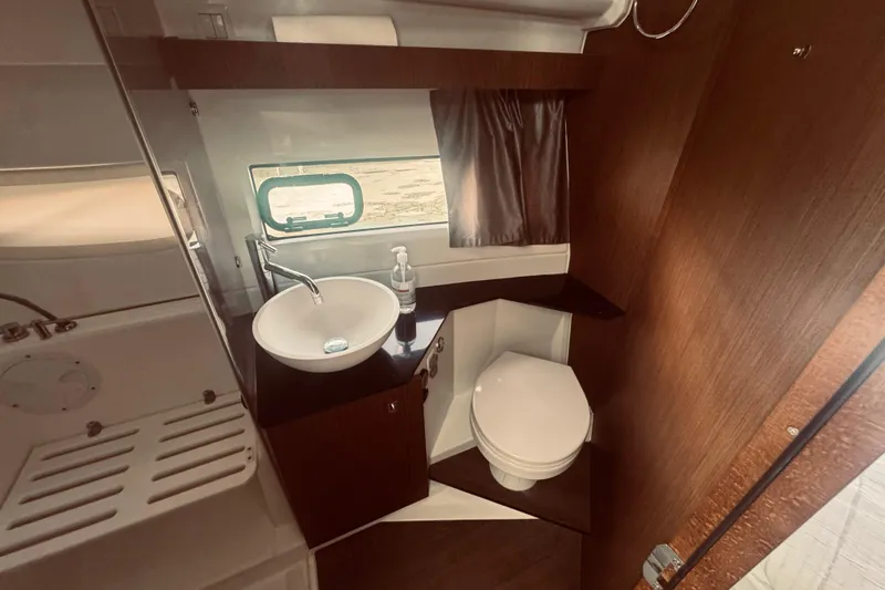 Last Tango Yacht Photos Pics Bathroom interior of 2020 Jeanneau NC 1095 boat with sink and toilet.