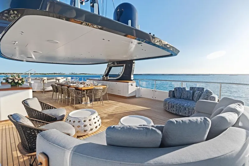  Yacht Photos Pics Luxurious deck of 2024 Benetti Oasis 40 yacht with elegant seating and dining area.