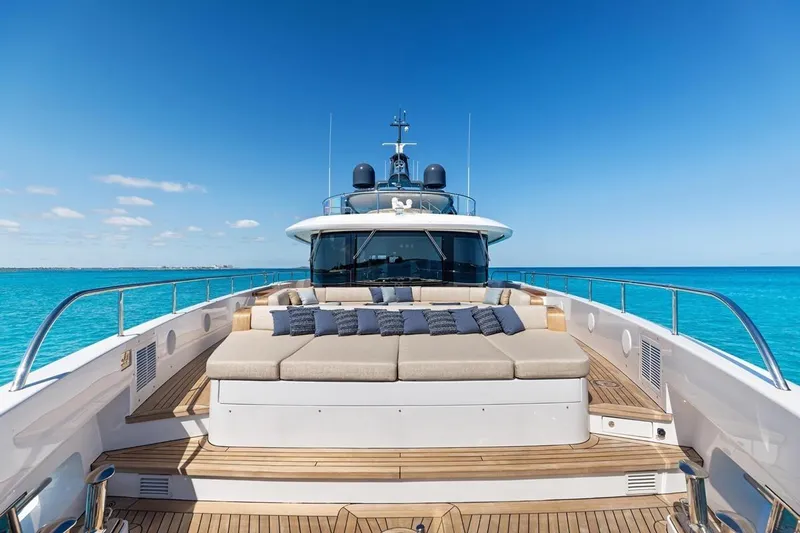  Yacht Photos Pics Luxurious 2024 Benetti Oasis 40 yacht deck with sun loungers, surrounded by clear blue ocean.