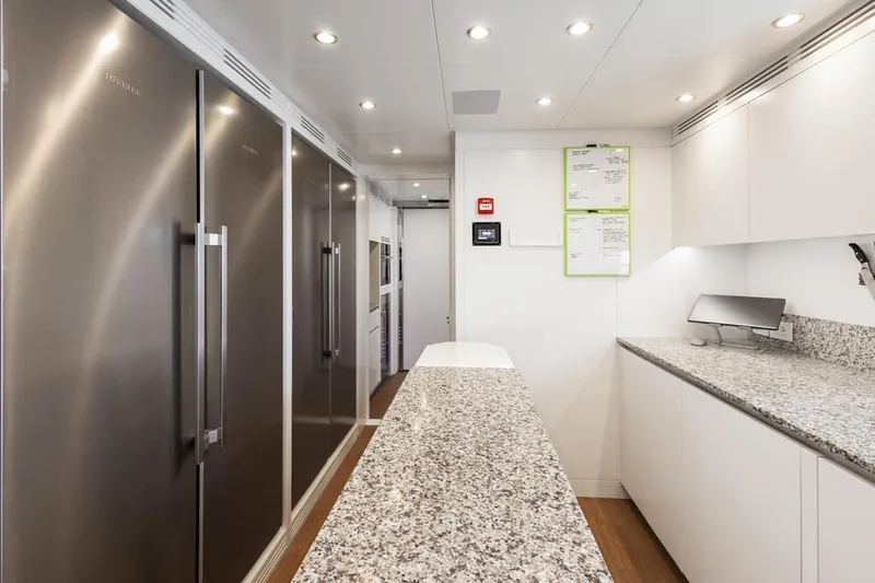  Yacht Photos Pics Modern kitchen interior on 2024 Benetti Oasis 40 yacht with sleek appliances and granite countertops.