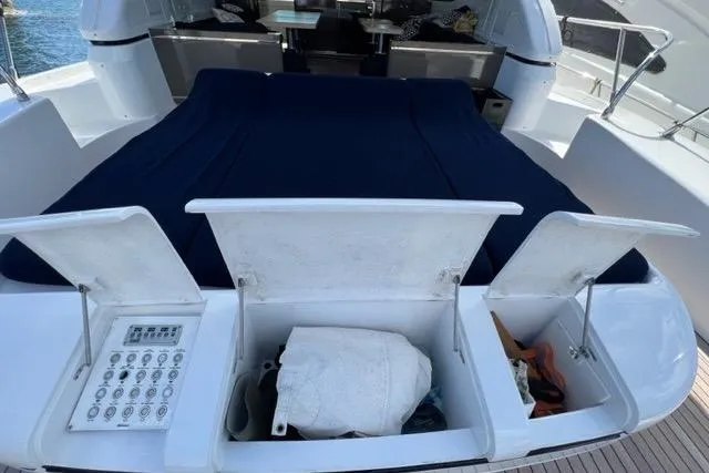  Yacht Photos Pics 2009 Overmarine Mangusta 72 HT yacht with open storage compartments and covered seating area.