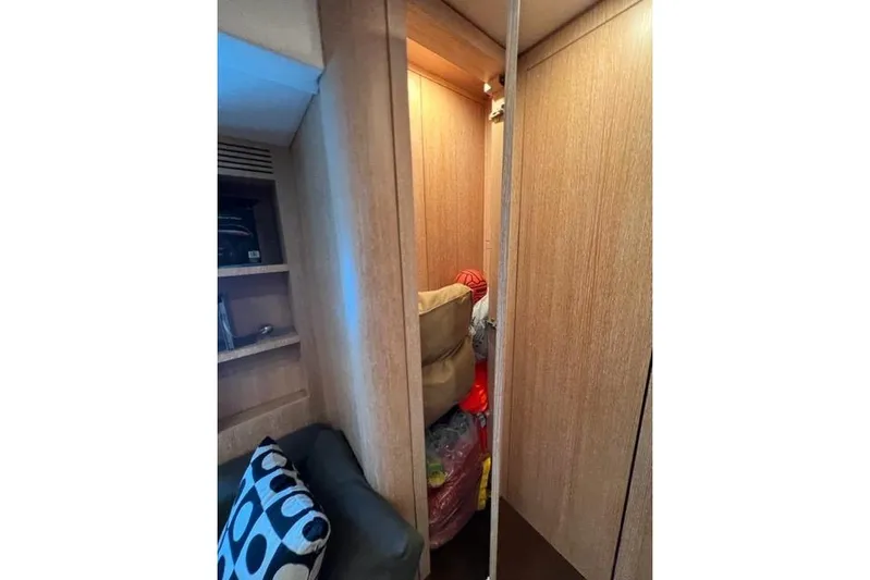  Yacht Photos Pics Interior of 2009 Overmarine Mangusta 72 HT yacht with wooden cabinetry and storage space.