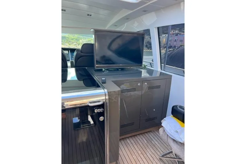  Yacht Photos Pics 2009 Overmarine Mangusta 72 HT yacht interior with TV and seating area.