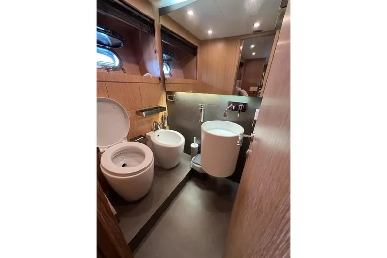  Yacht Photos Pics Luxurious bathroom in 2009 Overmarine Mangusta 72 HT yacht, featuring modern fixtures and wood accents.