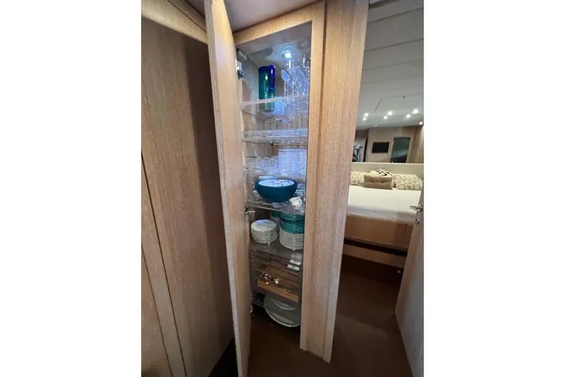  Yacht Photos Pics Luxurious interior of 2009 Overmarine Mangusta 72 HT yacht with elegant glassware display.