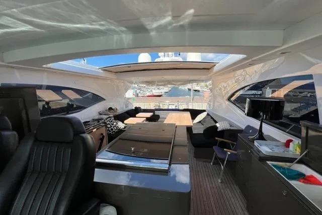  Yacht Photos Pics Luxurious interior of 2009 Overmarine Mangusta 72 HT yacht with open roof and elegant seating.