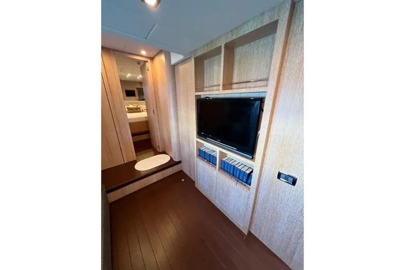  Yacht Photos Pics Luxurious interior of 2009 Overmarine Mangusta 72 HT yacht with TV and shelving.