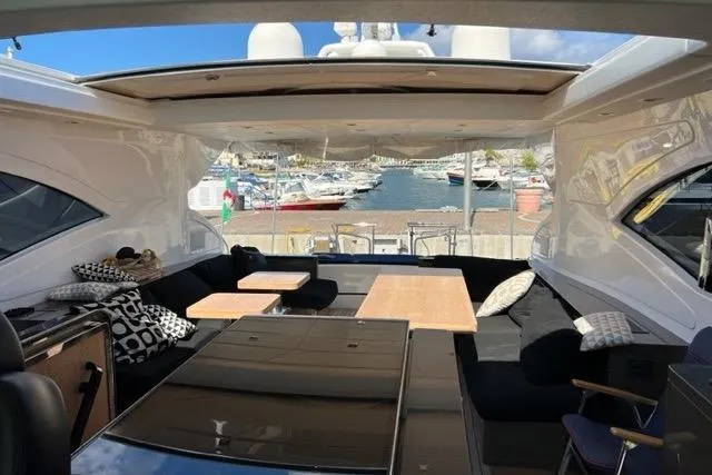  Yacht Photos Pics Luxurious 2009 Overmarine Mangusta 72 HT yacht interior with open roof and marina view.