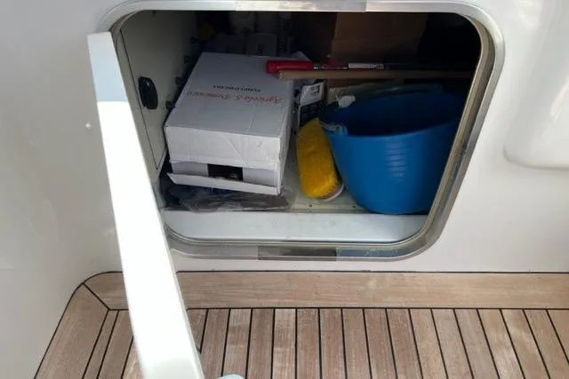  Yacht Photos Pics Storage compartment on 2009 Overmarine Mangusta 72 HT yacht with cleaning supplies and tools.