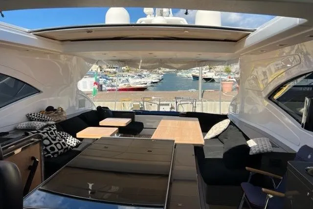  Yacht Photos Pics Luxurious 2009 Overmarine Mangusta 72 HT yacht interior with open seating and marina view.