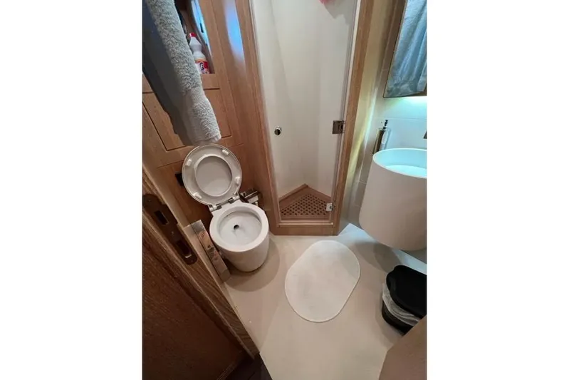  Yacht Photos Pics Bathroom interior of 2009 Overmarine Mangusta 72 HT yacht, featuring toilet and shower.