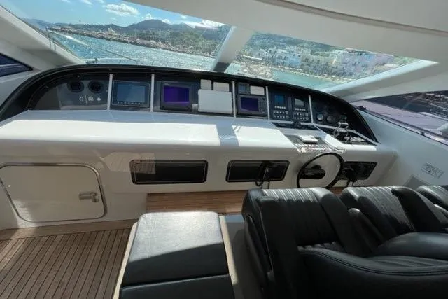  Yacht Photos Pics Cockpit of 2009 Overmarine Mangusta 72 HT yacht with modern navigation equipment.