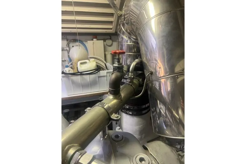  Yacht Photos Pics Engine room of 2009 Overmarine Mangusta 72 HT yacht, featuring metallic pipes and valves.