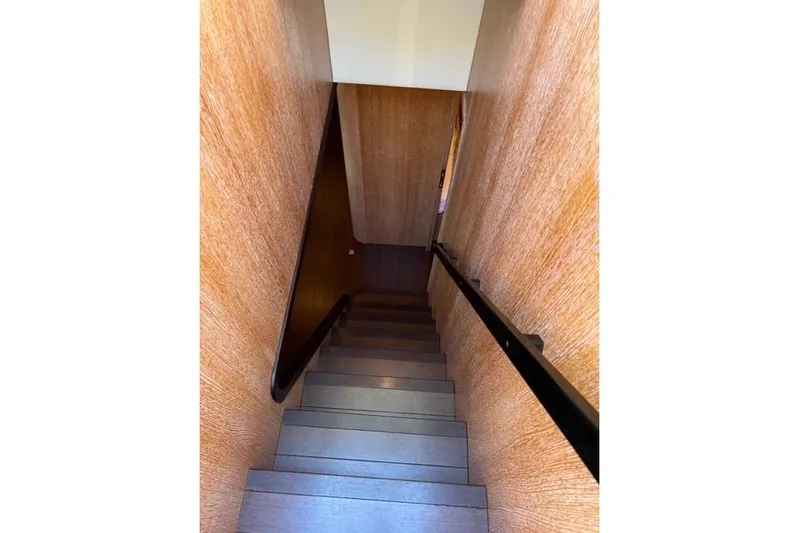  Yacht Photos Pics Staircase inside 2009 Overmarine Mangusta 72 HT yacht with wooden walls and sleek design.