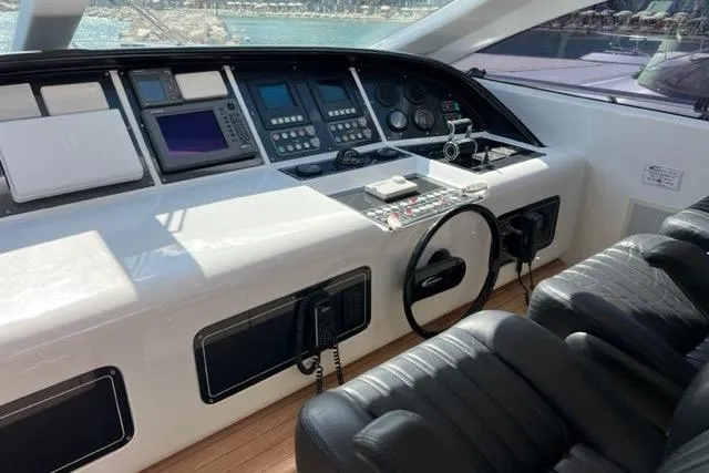  Yacht Photos Pics Cockpit of 2009 Overmarine Mangusta 72 HT yacht with navigation controls and leather seating.