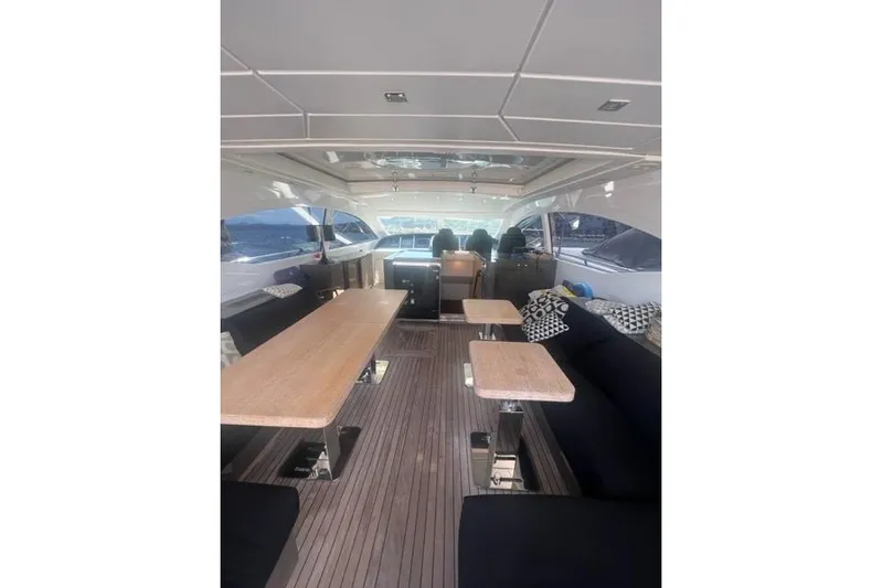  Yacht Photos Pics Luxurious interior of 2009 Overmarine Mangusta 72 HT yacht with elegant seating and tables.