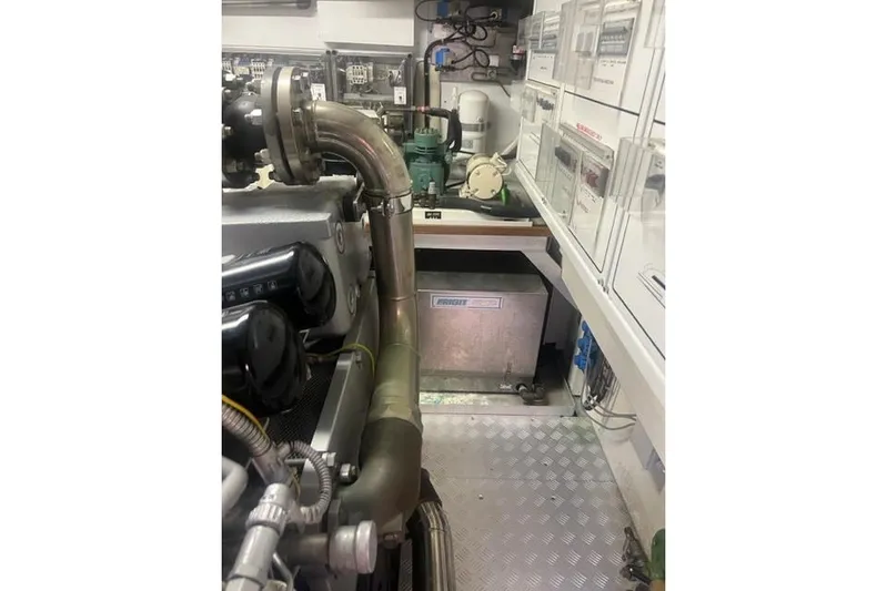  Yacht Photos Pics Engine room of 2009 Overmarine Mangusta 72 HT yacht, showcasing machinery and piping.