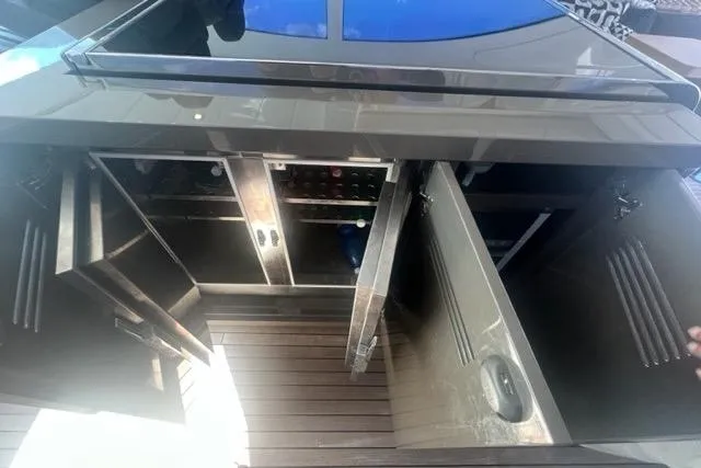  Yacht Photos Pics Luxurious 2009 Overmarine Mangusta 72 HT yacht interior with open storage compartments.