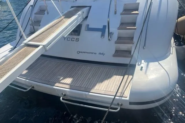  Yacht Photos Pics Sleek 2009 Overmarine Mangusta 72 HT yacht with boarding ramp and teak deck.