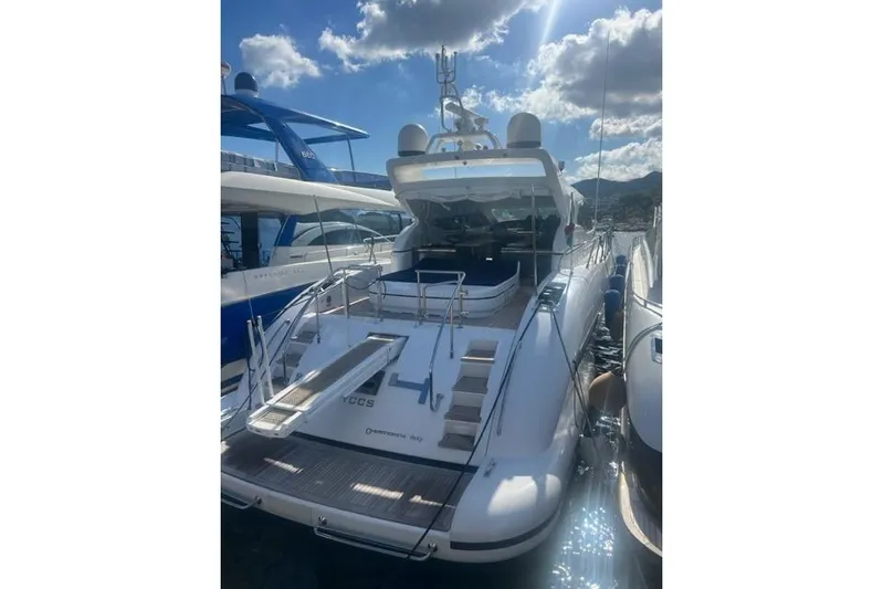  Yacht Photos Pics Luxury 2009 Overmarine Mangusta 72 HT yacht docked under a sunny sky.