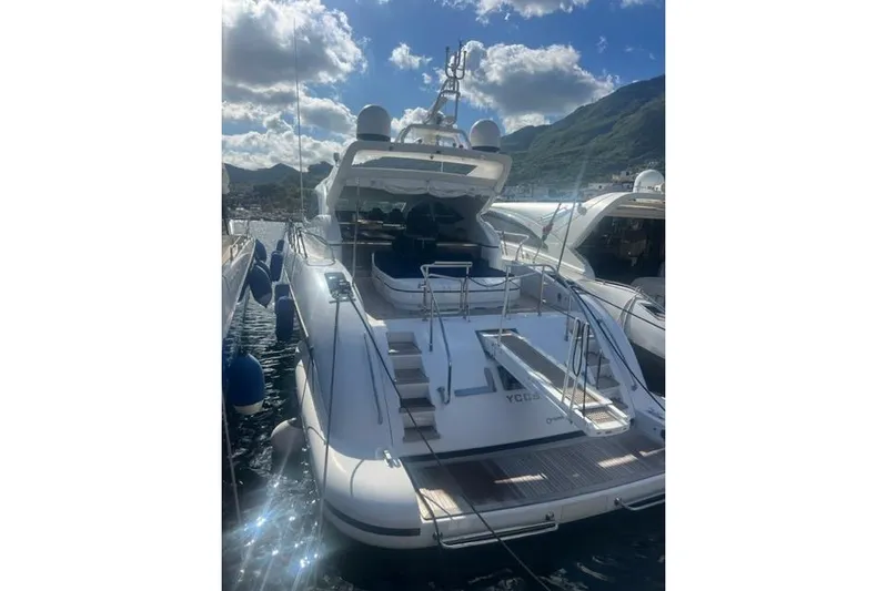  Yacht Photos Pics Luxury 2009 Overmarine Mangusta 72 HT yacht docked under a sunny sky.