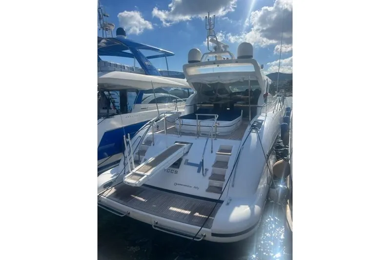  Yacht Photos Pics Luxury 2009 Overmarine Mangusta 72 HT yacht docked under a sunny sky.