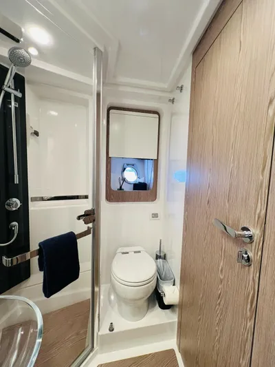  Yacht Photos Pics Luxurious bathroom in 2022 Azimut S6F yacht, featuring modern fixtures and elegant wood accents.