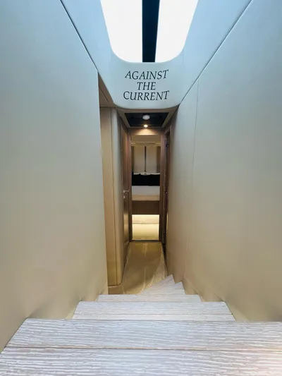  Yacht Photos Pics Interior staircase of 2022 Azimut S6F yacht with "Against the Current" sign.