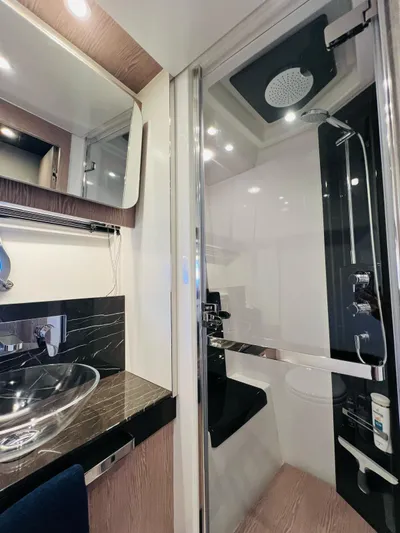  Yacht Photos Pics Luxurious bathroom in 2022 Azimut S6F yacht with modern fixtures and glass shower.