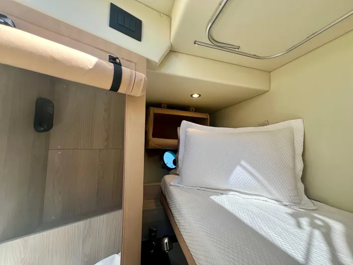  Yacht Photos Pics Cozy cabin interior of 2022 Azimut S6F yacht with bed and wooden accents.