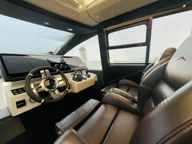  Yacht Photos Pics Luxurious interior of 2022 Azimut S6F yacht with leather seating and modern dashboard.