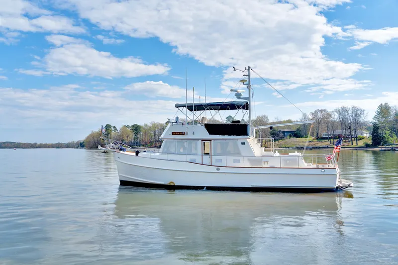 Lu-sea-lu Yacht Photos Pics 1994 Grand Banks 42 Classic yacht on calm water under a blue sky.